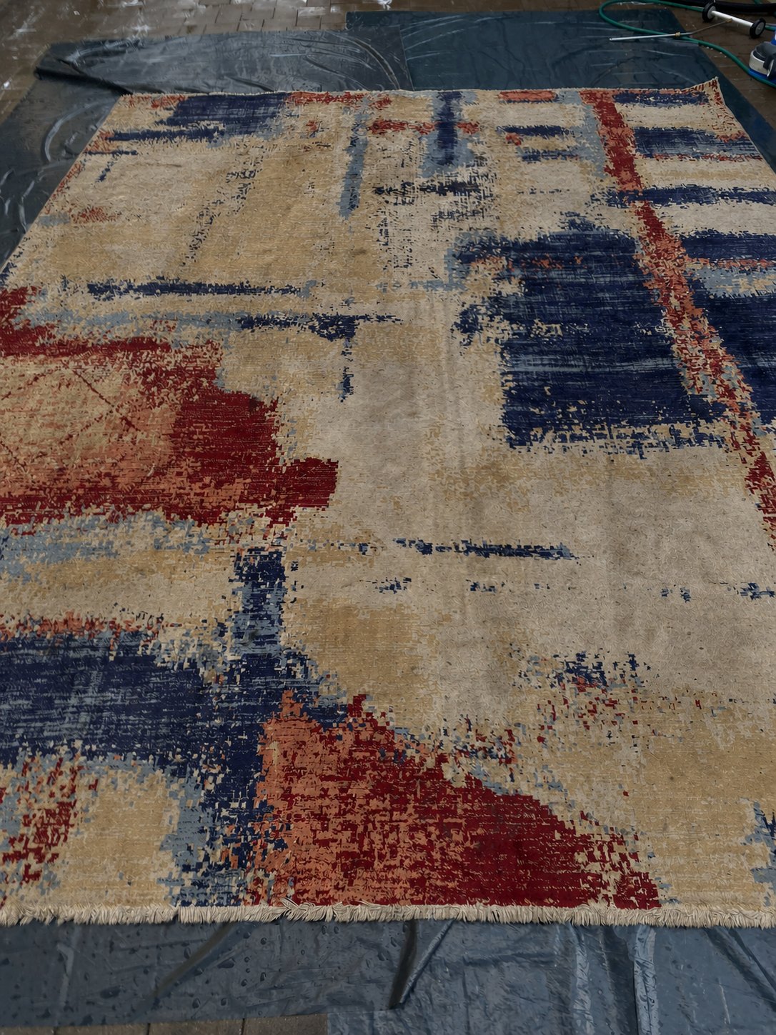 Temporary visual of a soiled patterned loose rug before professional cleaning