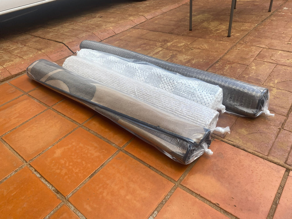 Clean loose rugs rolled and sealed in clear protective packaging for return